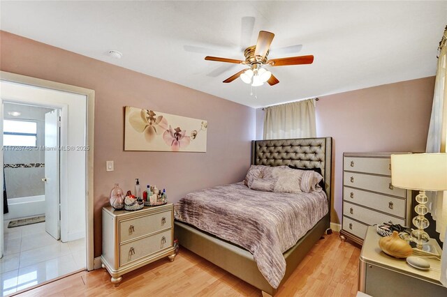 kitchen featuring light tile patterned floors, stainless steel fridge, and washer / clothes dryer