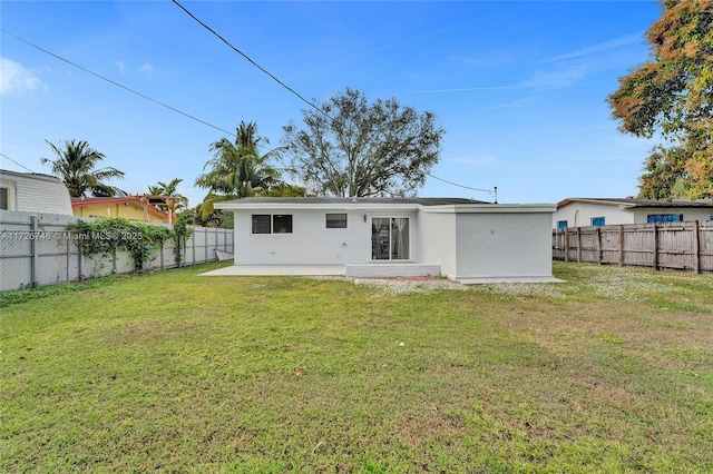 rear view of property featuring cooling unit and a lawn