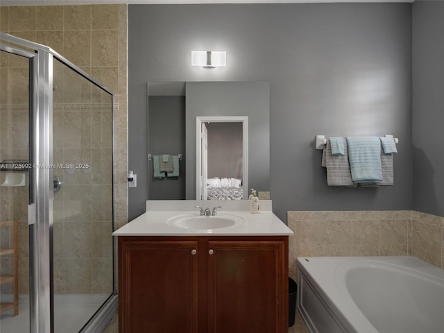 bathroom featuring vanity and independent shower and bath