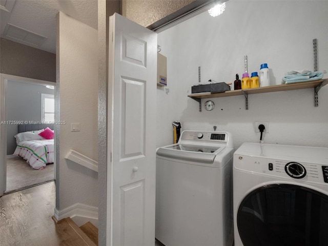 clothes washing area featuring light hardwood / wood-style floors and independent washer and dryer