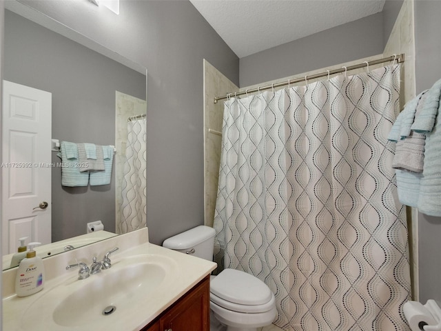 bathroom featuring toilet, a textured ceiling, curtained shower, and vanity