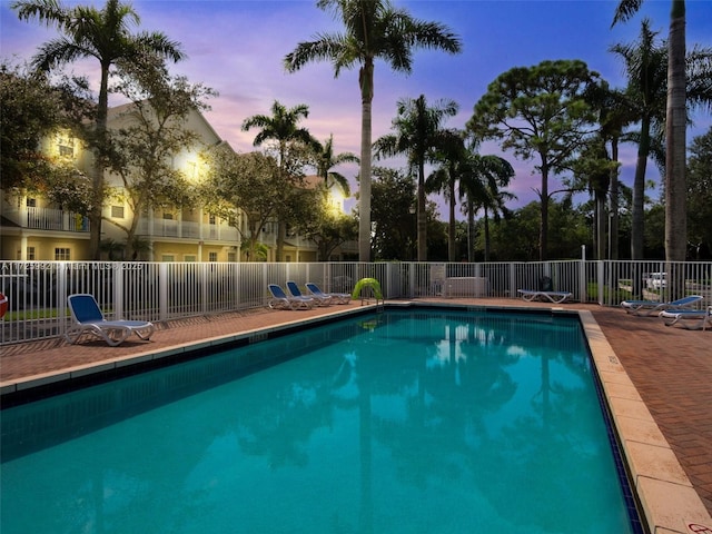 view of pool at dusk