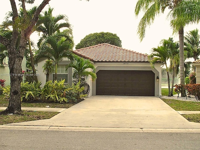 mediterranean / spanish-style house with a garage