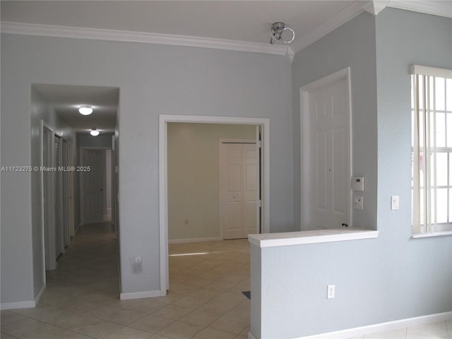 spare room with light tile patterned flooring and crown molding