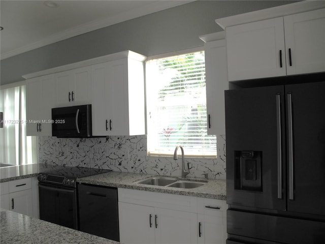 kitchen featuring refrigerator with ice dispenser, white cabinetry, decorative backsplash, electric stove, and sink