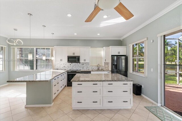 kitchen featuring tasteful backsplash, light tile patterned floors, ornamental molding, a ceiling fan, and stainless steel appliances