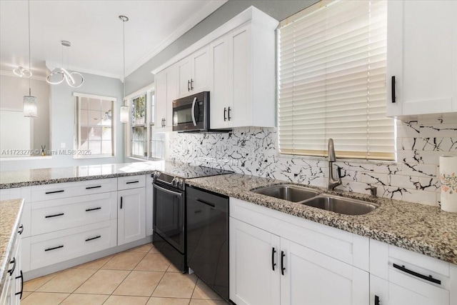 kitchen featuring white cabinets, black dishwasher, stainless steel microwave, a sink, and range with electric cooktop