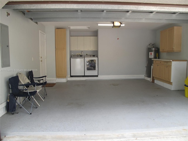 garage featuring water heater, a garage door opener, electric panel, and washer and clothes dryer