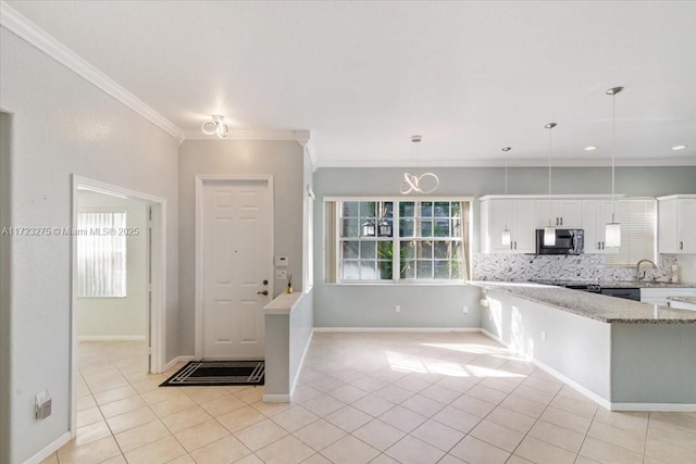 kitchen with light tile patterned floors, light stone countertops, tasteful backsplash, ornamental molding, and white cabinetry