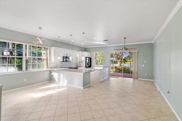 kitchen with black microwave, white cabinetry, ornamental molding, and refrigerator with ice dispenser