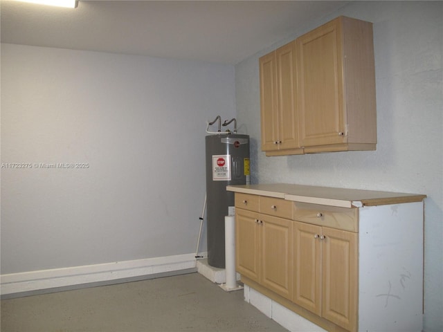 interior space with light brown cabinets and water heater