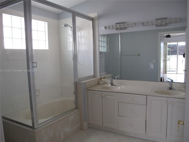 bathroom featuring ceiling fan, tile patterned flooring, enclosed tub / shower combo, and vanity