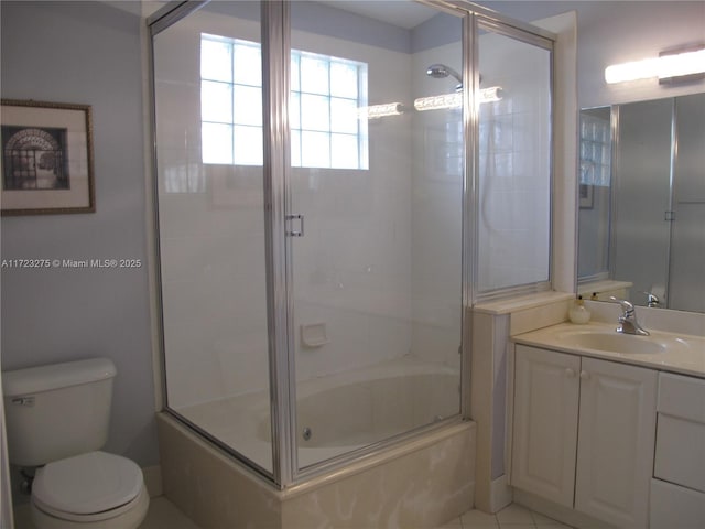 full bathroom with tile patterned floors, shower / bath combination with glass door, vanity, and toilet