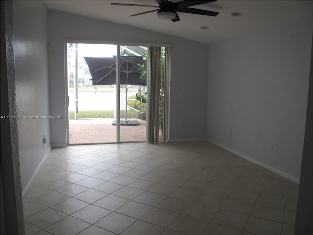 tiled spare room featuring ceiling fan and lofted ceiling