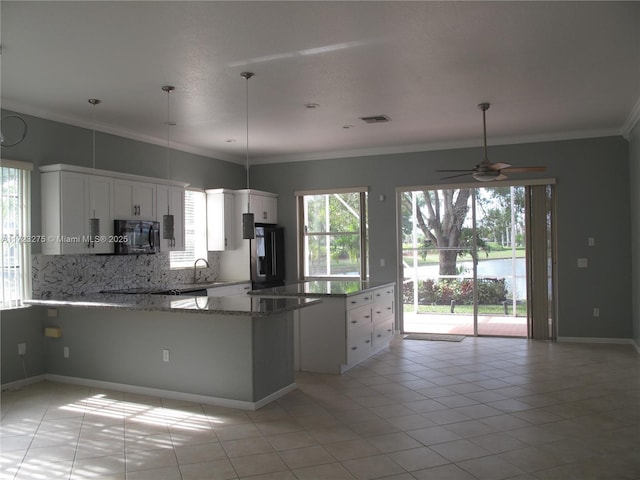 kitchen featuring kitchen peninsula, fridge, light tile patterned flooring, crown molding, and white cabinets