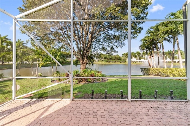 unfurnished sunroom with a water view