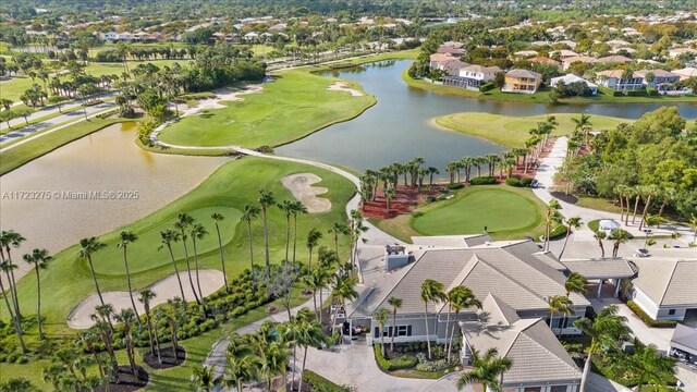 aerial view with a water view, golf course view, and a residential view