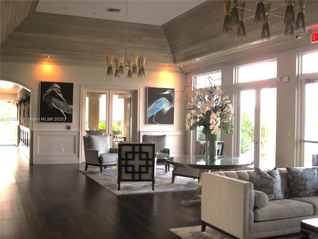 living room with hardwood / wood-style flooring and a notable chandelier