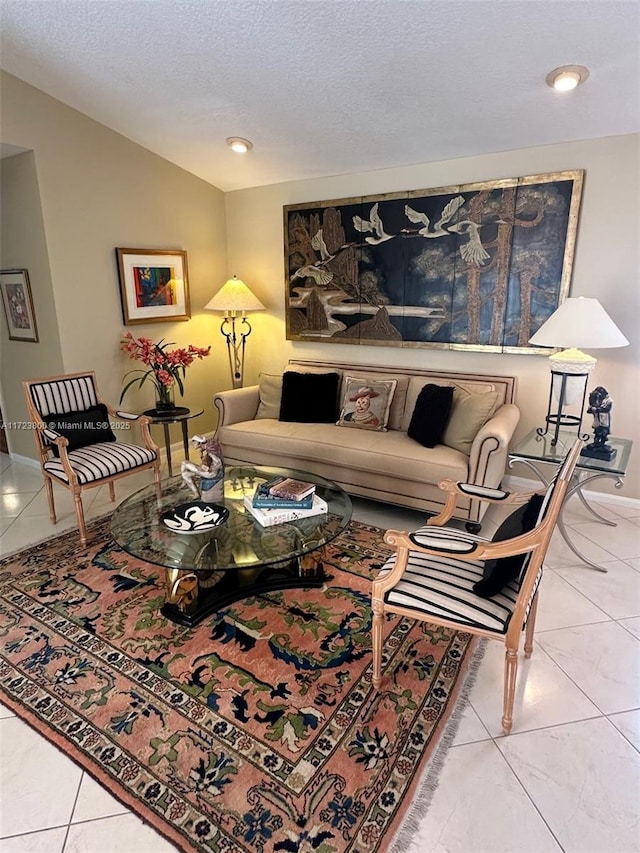 living room with a textured ceiling, lofted ceiling, and tile patterned flooring