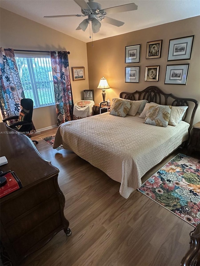 bedroom featuring ceiling fan, lofted ceiling, and hardwood / wood-style flooring