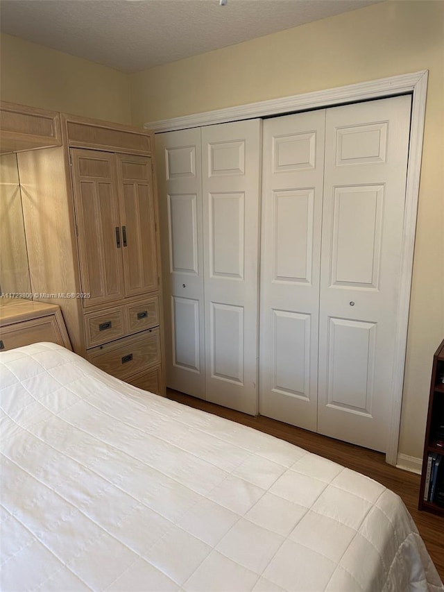 unfurnished bedroom with a closet and hardwood / wood-style floors