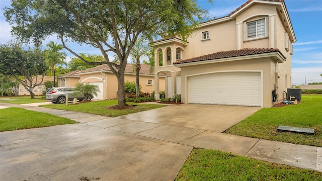 mediterranean / spanish-style house with central AC unit, a front lawn, and a garage