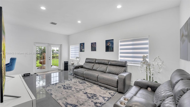 tiled living room with plenty of natural light and french doors