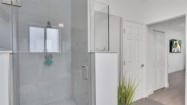 bathroom with hardwood / wood-style floors and walk in shower