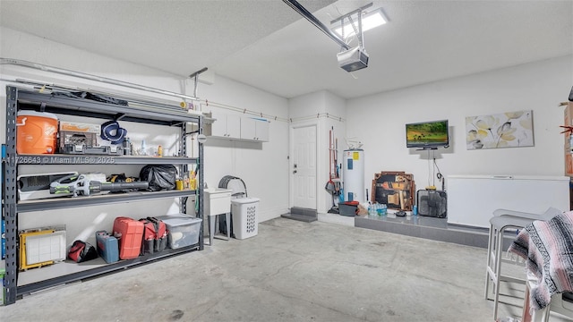 garage featuring water heater and a garage door opener