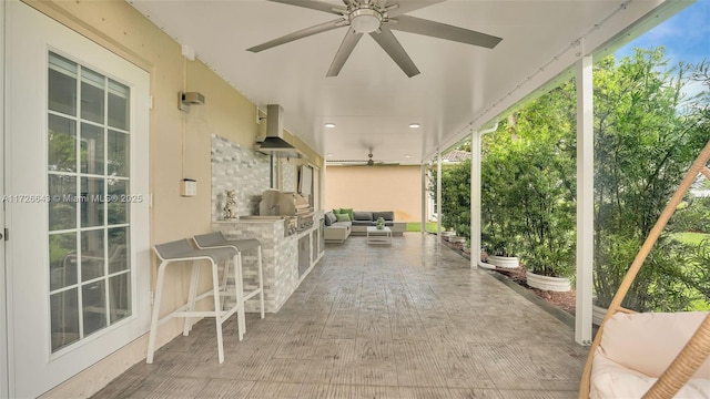 view of patio featuring an outdoor kitchen and an outdoor bar