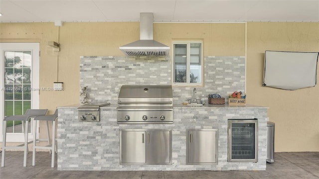 kitchen featuring decorative backsplash, island range hood, wine cooler, and sink