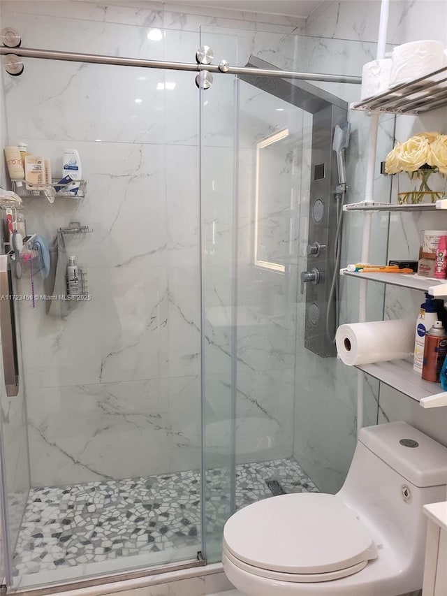 bathroom with toilet, walk in shower, and vanity