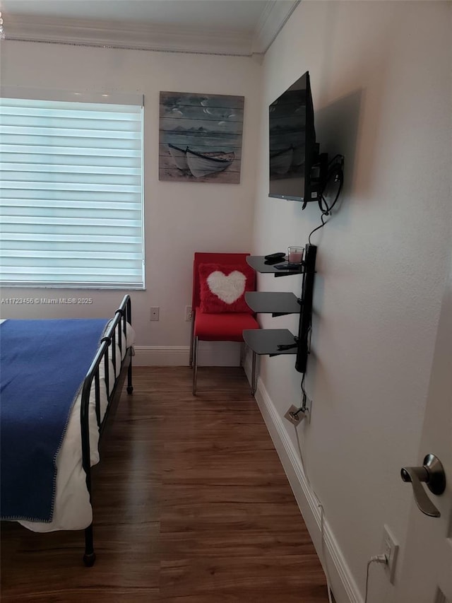 bedroom featuring dark hardwood / wood-style flooring and ornamental molding