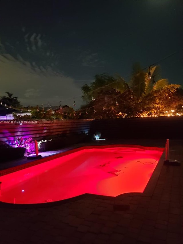 view of pool at night