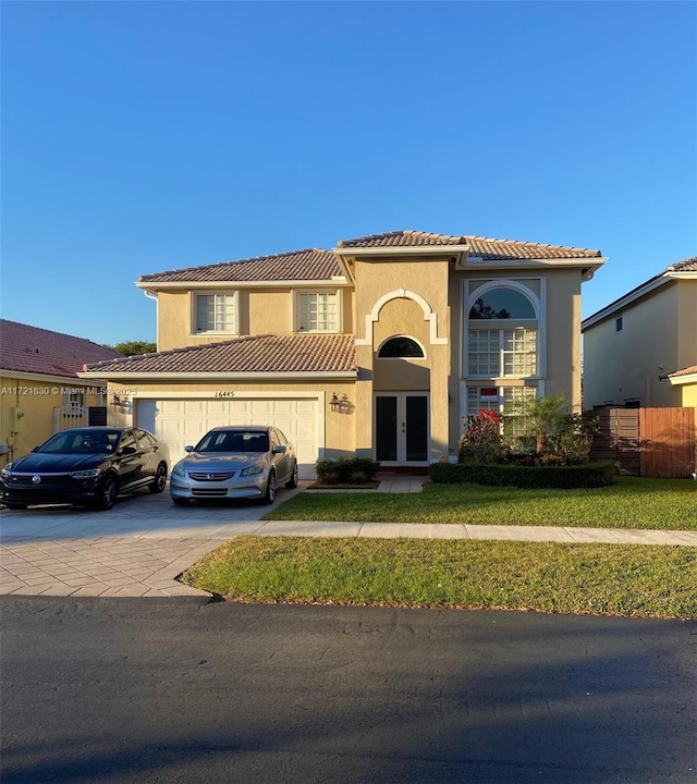 16445 SW 100th Ter, Miami, FL 33196 - mediterranean / spanish home with a garage, a front lawn, and french doors