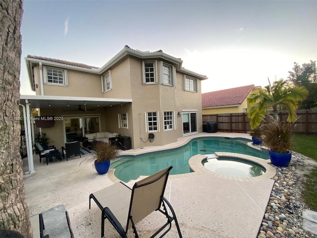 view of swimming pool with an in ground hot tub and a patio area