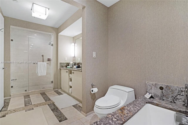 bathroom featuring toilet, vanity, tile patterned floors, and walk in shower