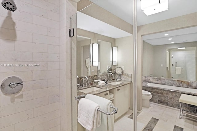 bathroom featuring toilet, tiled shower, and vanity