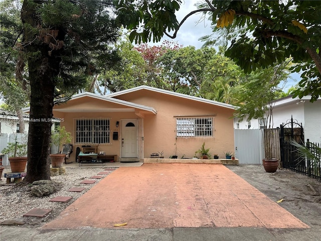 view of front of property featuring fence and stucco siding