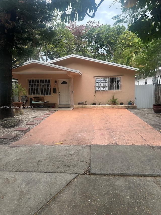 view of front of home with fence and stucco siding