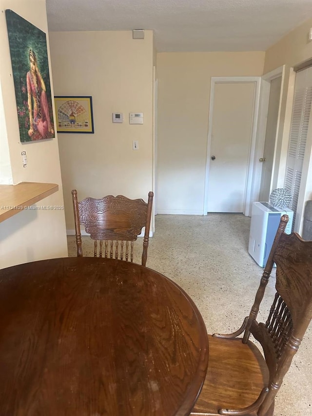 dining area with speckled floor