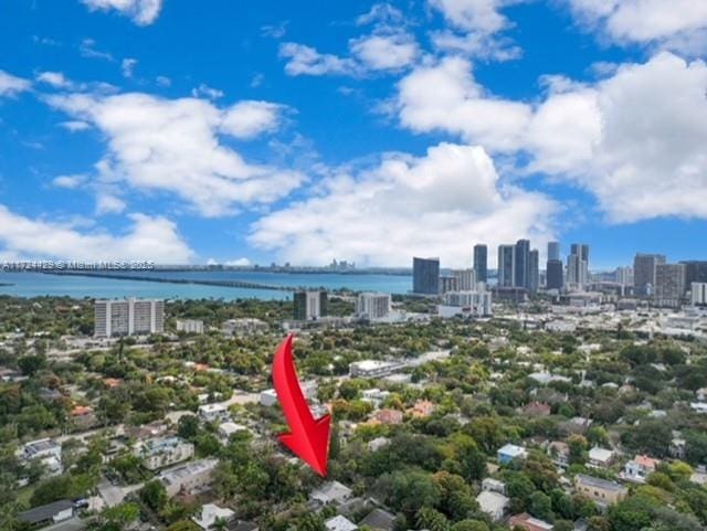 birds eye view of property with a view of city and a water view