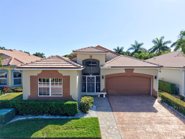 view of front facade with a garage and a front lawn