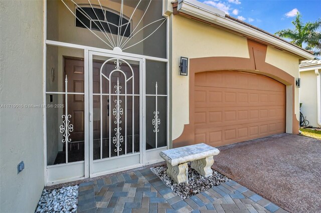 view of exterior entry with a garage