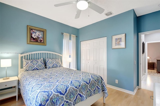 bedroom featuring ceiling fan, hardwood / wood-style floors, and a closet