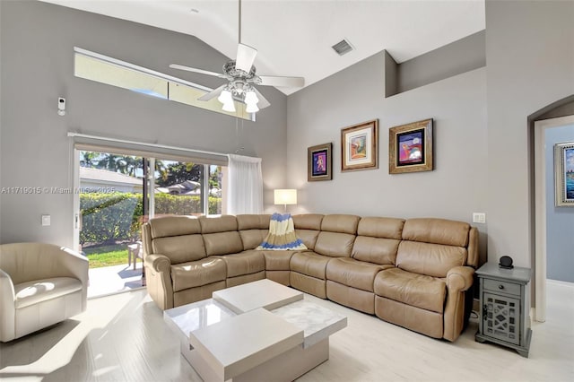 living room featuring ceiling fan, high vaulted ceiling, and light hardwood / wood-style floors