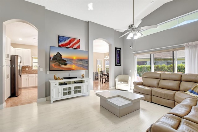 living room featuring ceiling fan and high vaulted ceiling