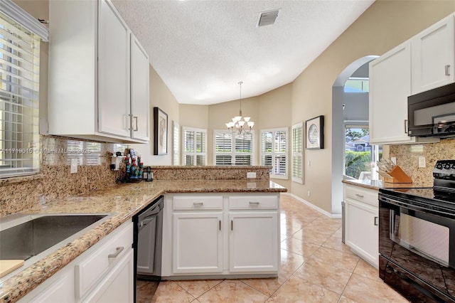 kitchen featuring white cabinets, kitchen peninsula, and black appliances