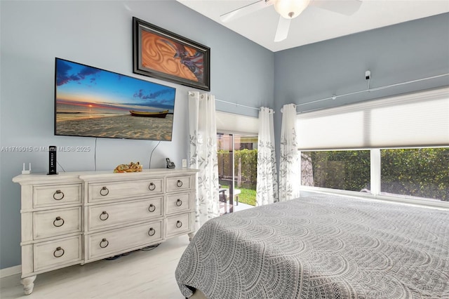 bedroom with multiple windows, access to outside, and ceiling fan