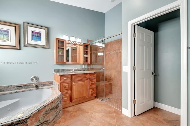 bathroom with tile patterned flooring, plus walk in shower, and vanity